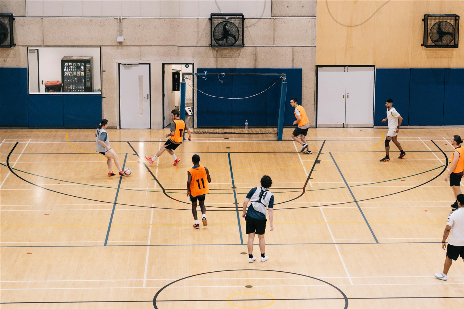 An elevated view of players and the marked indoor court at TAFE South Bank